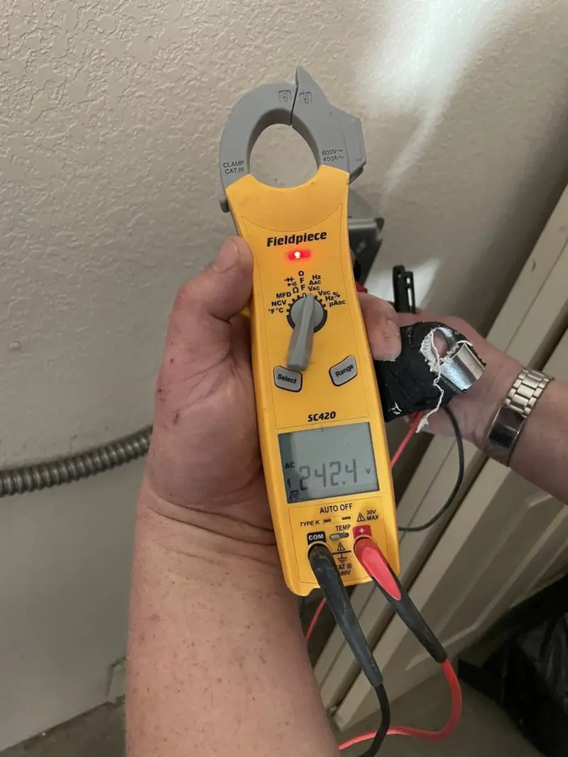 Voltage testing with clamp meter during Recessed Lighting Installation in Stewartville